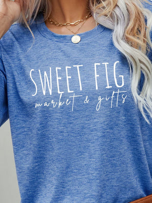 Cobalt blue graphic t-shirt with white "Sweet Fig market & gifts" text.