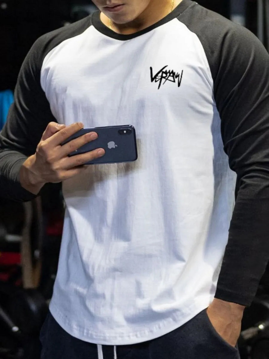 Raglan sleeve graphic tee in white with black sleeves and a black graphic logo.