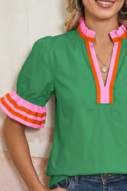 Green maternity overshirt with ruffled collar and striped ruffle sleeves.