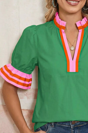 Green maternity overshirt with ruffled collar and striped ruffle sleeves.
