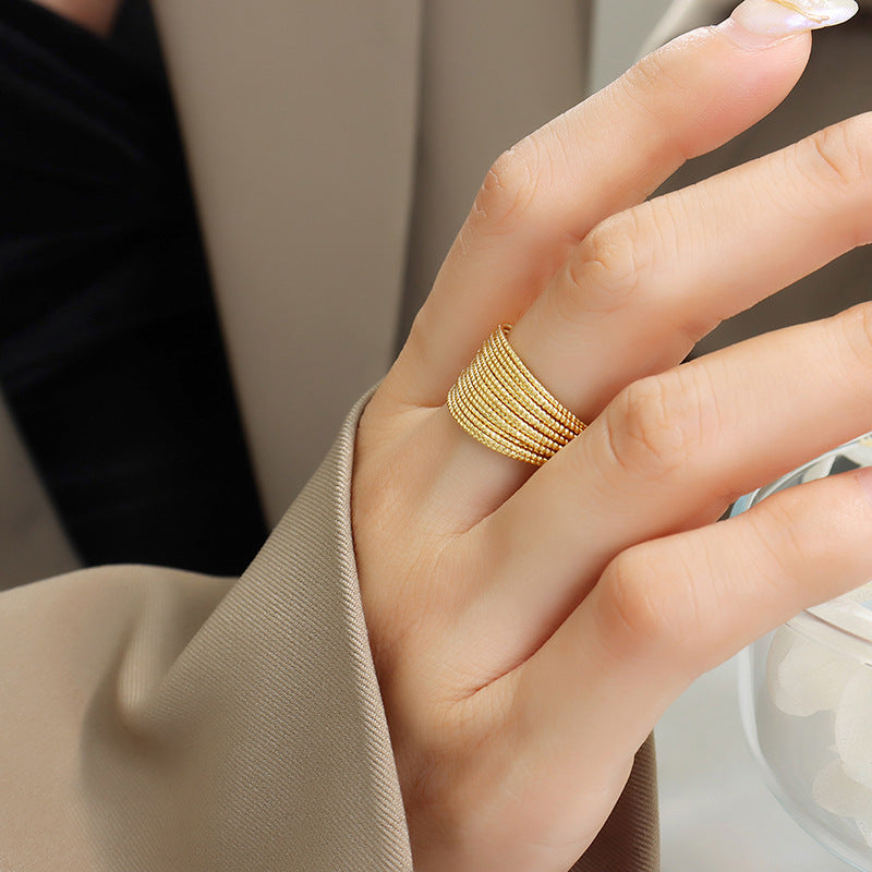 Gold textured coil open-ended ring with multiple strands