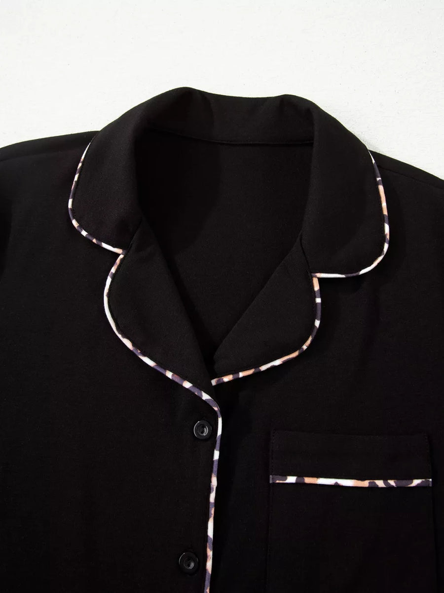 Black pajama set with leopard trim detail on collar, pocket, and buttons.