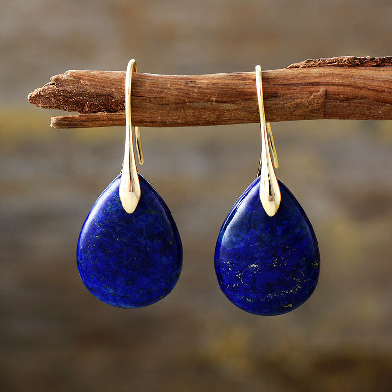 Gemstone teardrop leverback earrings in dark blue with gold accents.