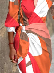 Shirt dress with abstract pattern, 3/4 sleeves, and waist tie in orange, red, and white.