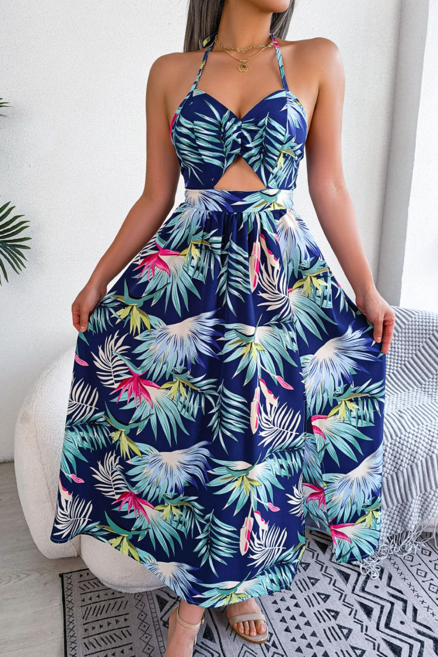Tropical halter maxi dress in dark blue with cutout and botanical print.