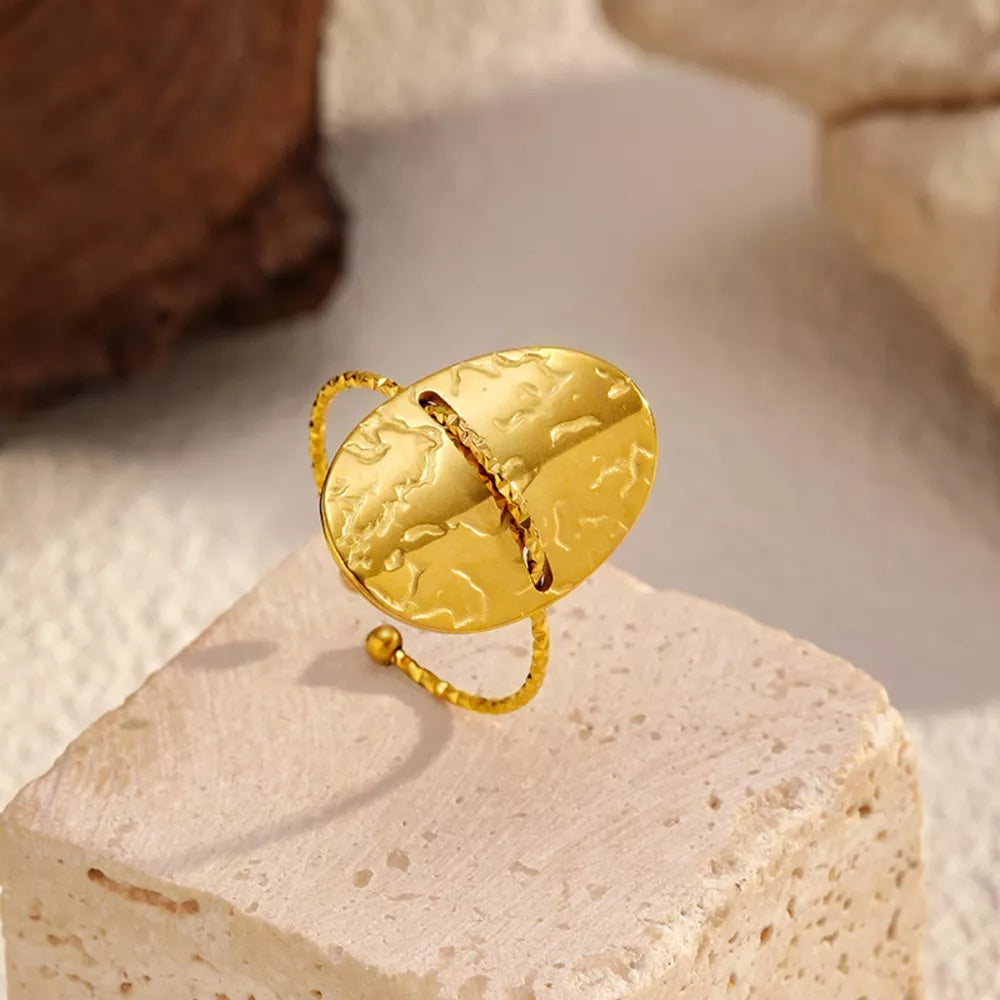 ring in gold featuring hammered texture and oval fit