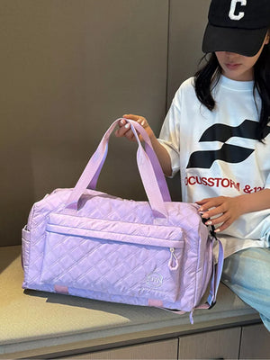 Diamond-quilted travel bag in Taro Purple with versatile straps and front pocket.