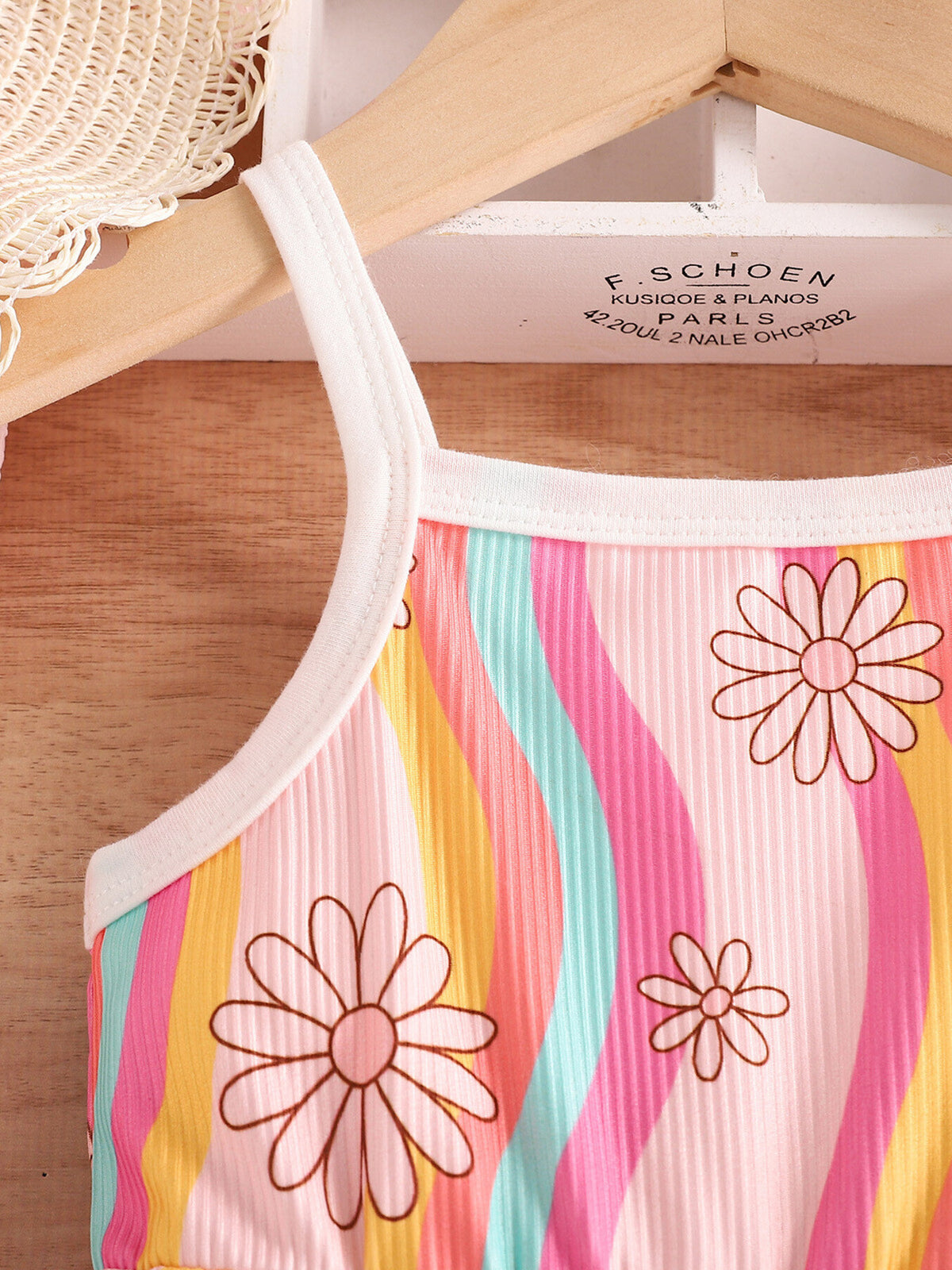 Baby jumpsuit with rainbow stripes and floral print, ribbed cotton fabric