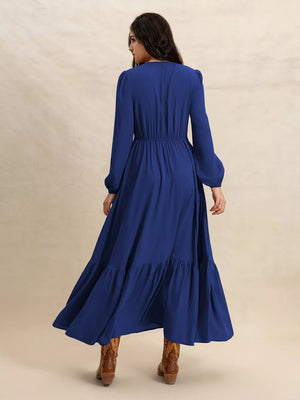 Blue viscose maxi dress with V-neck, long sleeves, elastic waist, and tiered hem.