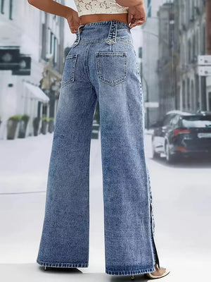 Wide-leg denim jeans with button accents and side slits, styled with a crop top.