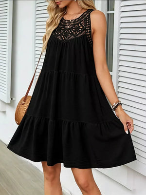 Black tiered dress with lace neckline and sleeveless design.