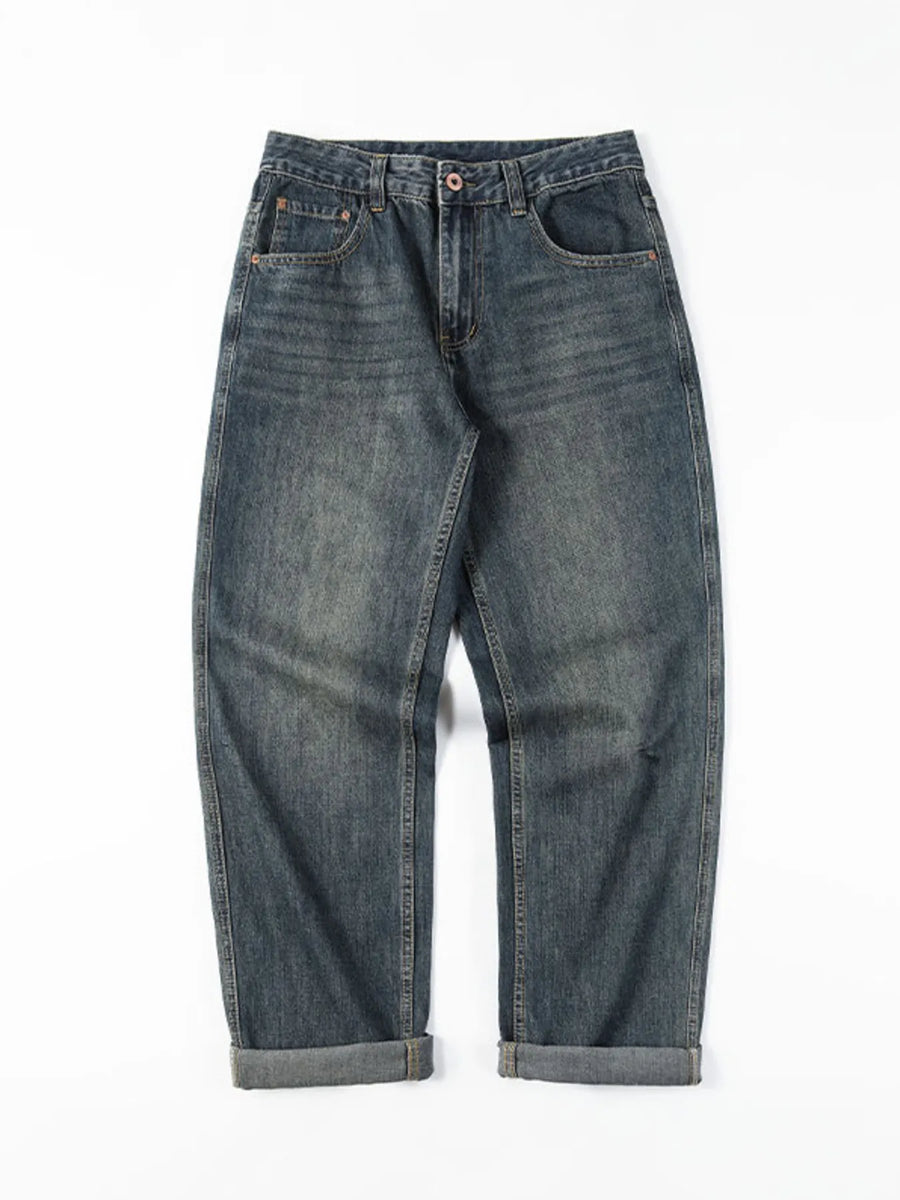 Loose fit blue cotton denim jeans with vintage wash and cuffed hems.