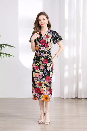 Black floral embroidered midi dress with V-neck and short flutter sleeves.