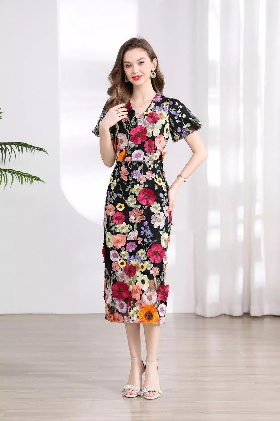Black floral embroidered midi dress with V-neck and short flutter sleeves.