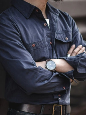Navy cotton twill utility shirt with two chest pockets and button front.