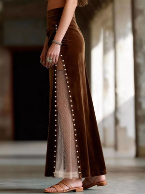 Dark brown velvet maxi skirt with pearl trim and sheer lace paneling.