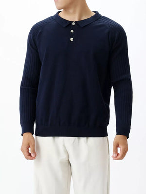 Navy blue cotton knit polo shirt with ribbed sleeves and button placket.