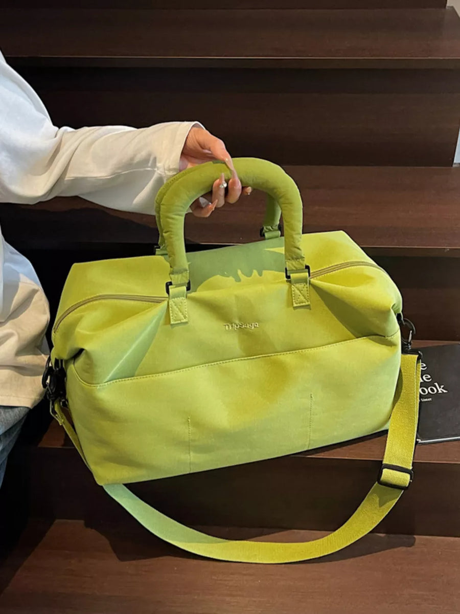 Lime green duffel bag with padded handles and adjustable shoulder strap.