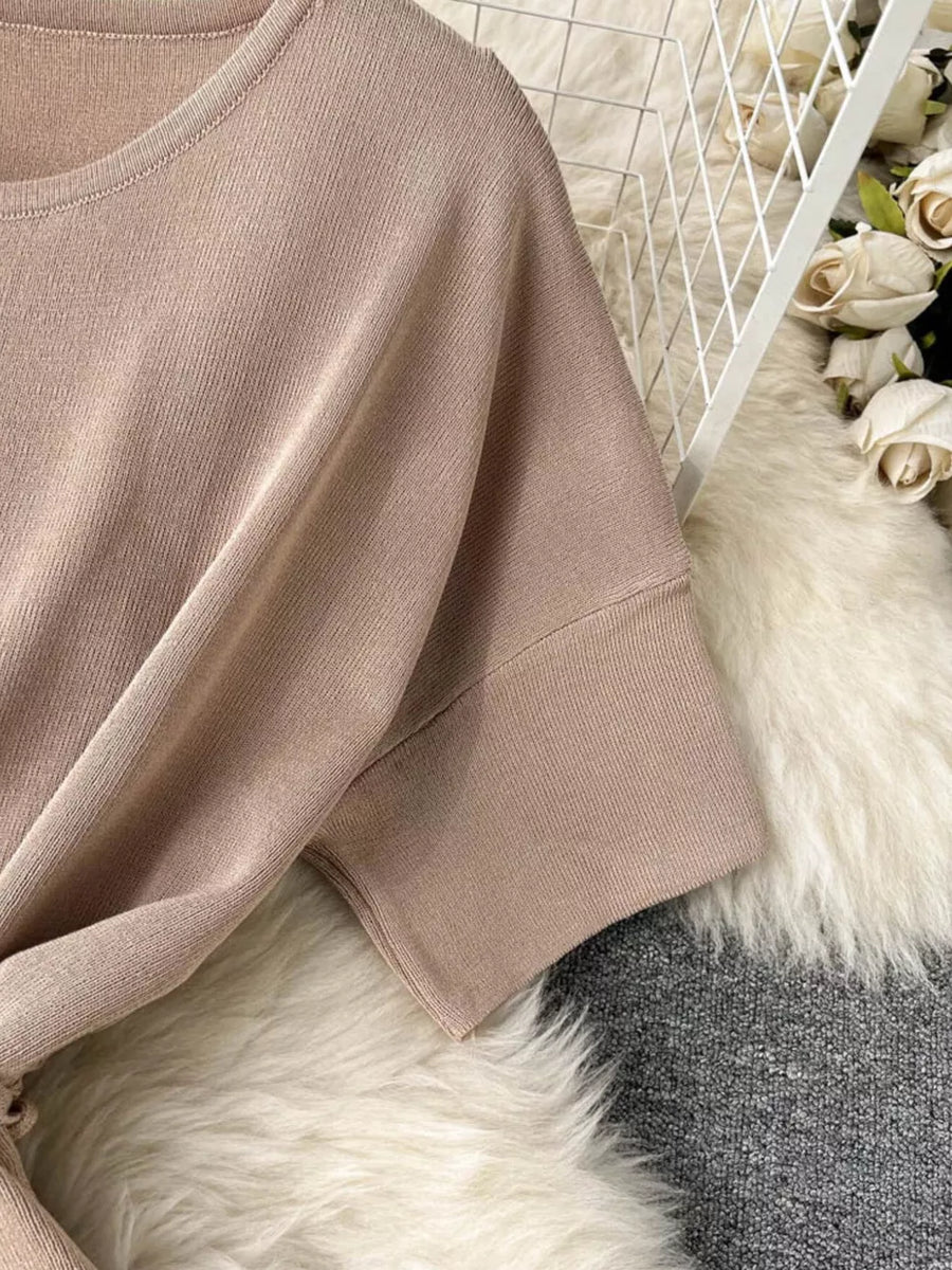 Apricot knit two-piece set with tied waist and wide legs, short sleeves.