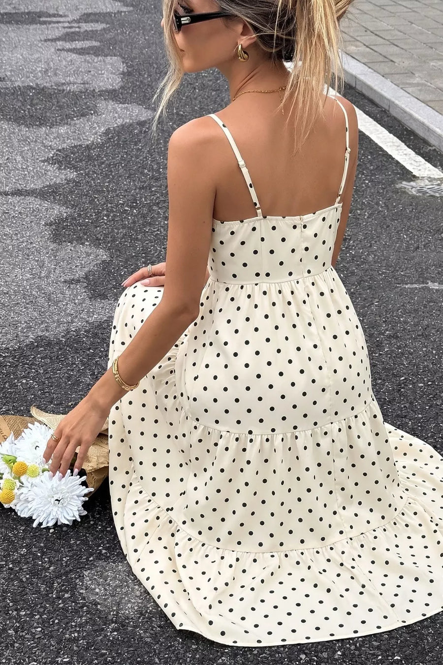 Cream polka dot maxi dress with tiered skirt and spaghetti straps.