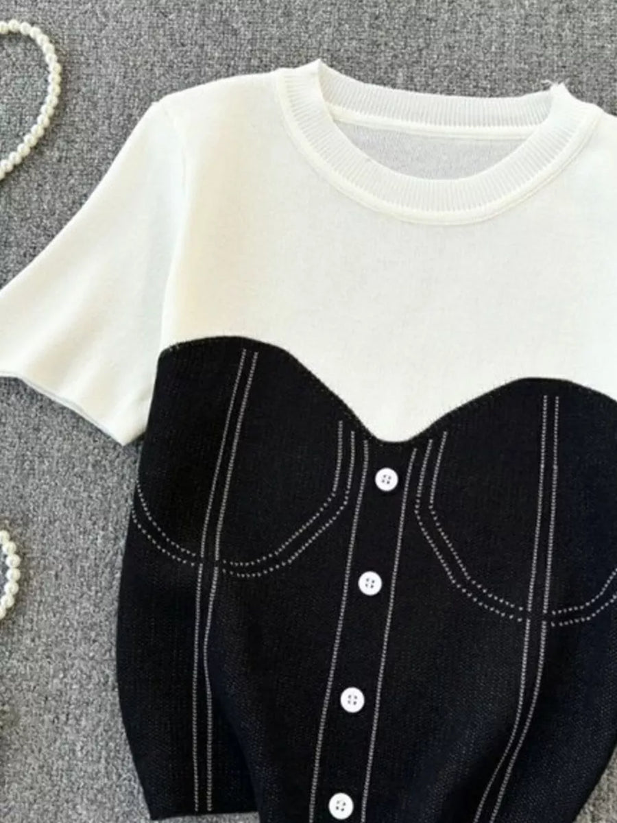 Color block knit t-shirt in white with black bustier detail and white buttons.