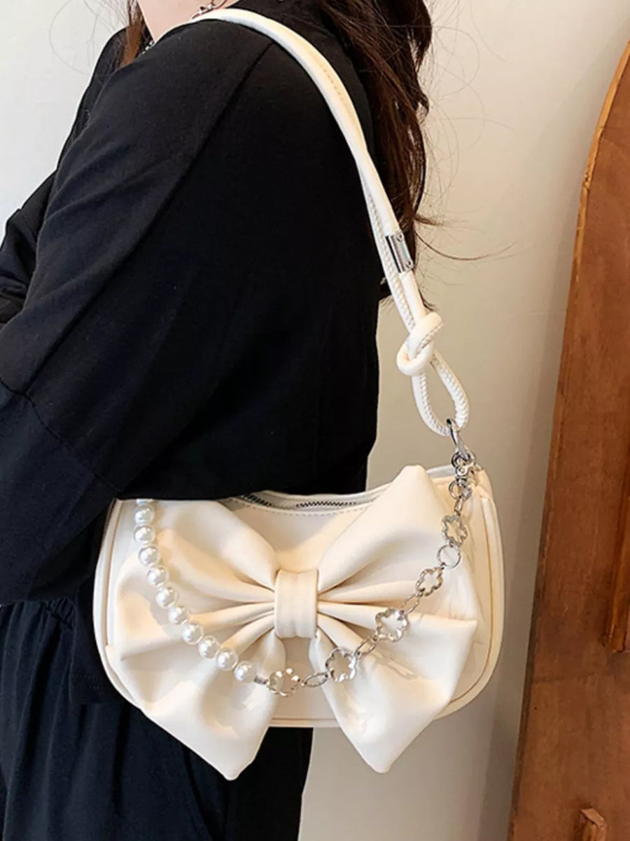 White bowknot shoulder bag with pearl and chain detail