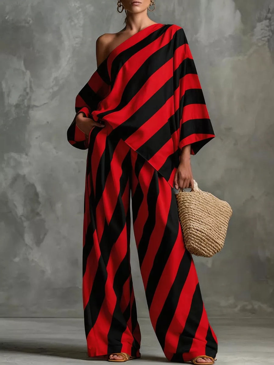 Red and black striped one-shoulder top with wide-leg pants.