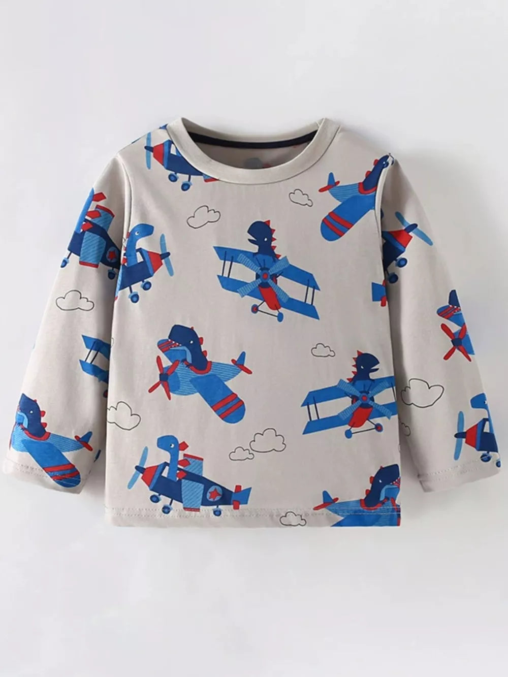 Toddler long sleeve t-shirt in beige with a playful all-over print of blue and red cartoon airplanes and clouds.