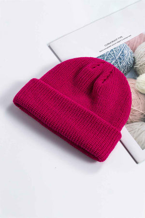 Ribbed knit beanie in magenta with a turn-up cuff.