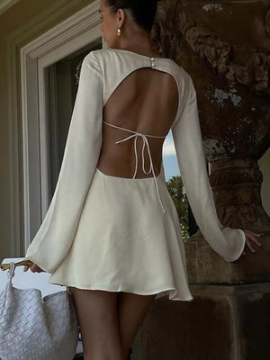 Cream long sleeve mini dress with open back and tie detail