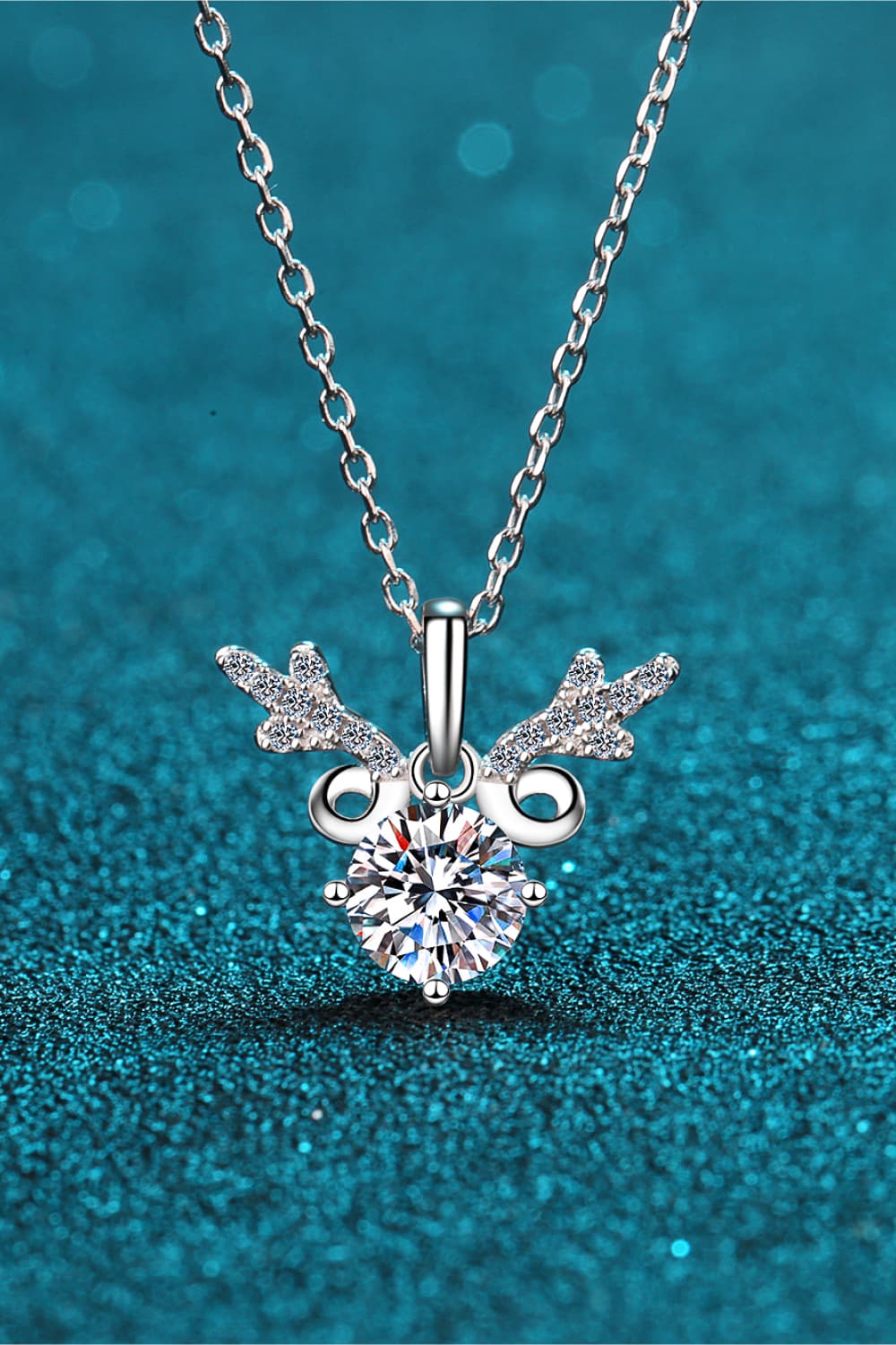 Silver reindeer pendant necklace with moissanite and 925 sterling silver chain.