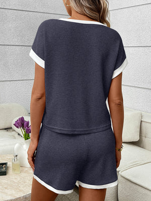 Navy ribbed knit short set with white trim, featuring a crew neck top and elastic waistband shorts.