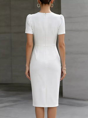 White midi dress with short puff sleeves, ruched waist detail, and a back zipper.