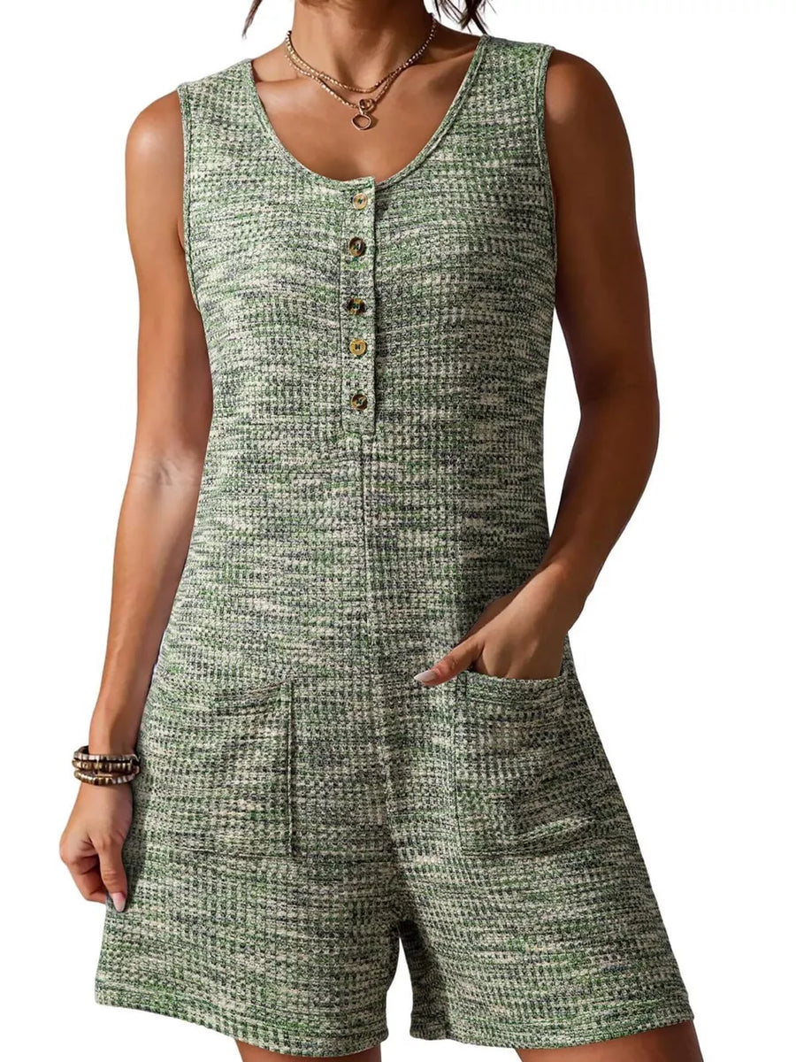 Textured button front romper in green with scoop neck, sleeveless, and patch pockets.