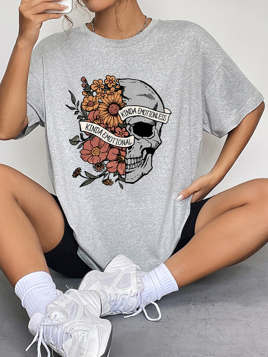 Grey oversized tee with a skull and floral graphic that says "Kinda Emotional" and "Kinda Emotionless".