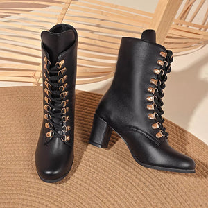 Black lace-up block heel boots with gold eyelets and laces.