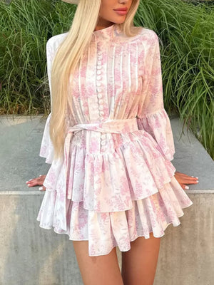 Pink floral print mini dress with tiered skirt and ruffled sleeves.