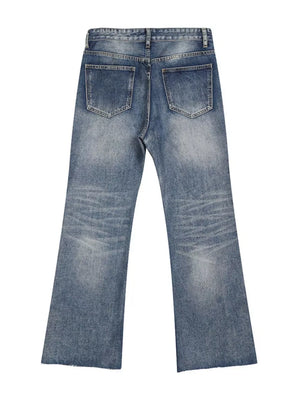 Men's blue wash denim flare jeans with distressed details and raw hem.