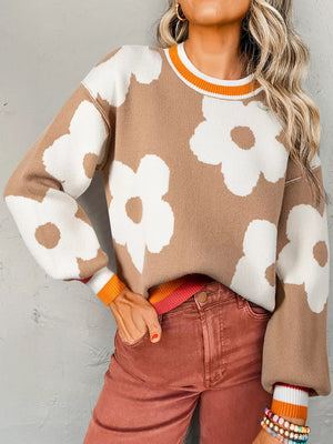 Floral pattern baggy sweater in tan with white flowers, crew neck, and striped cuffs.