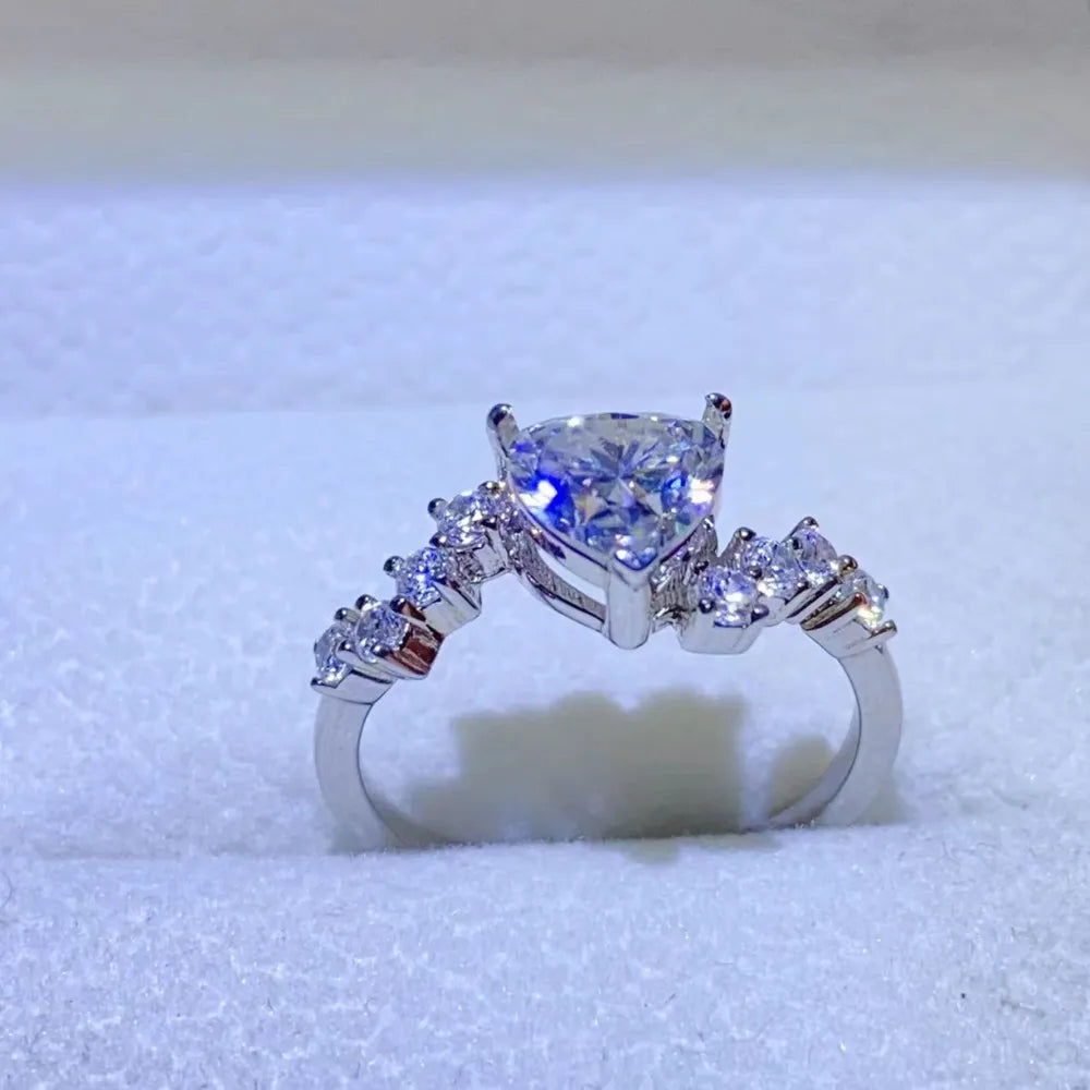 Silver ring with a heart-cut diamond cluster and accent stones.