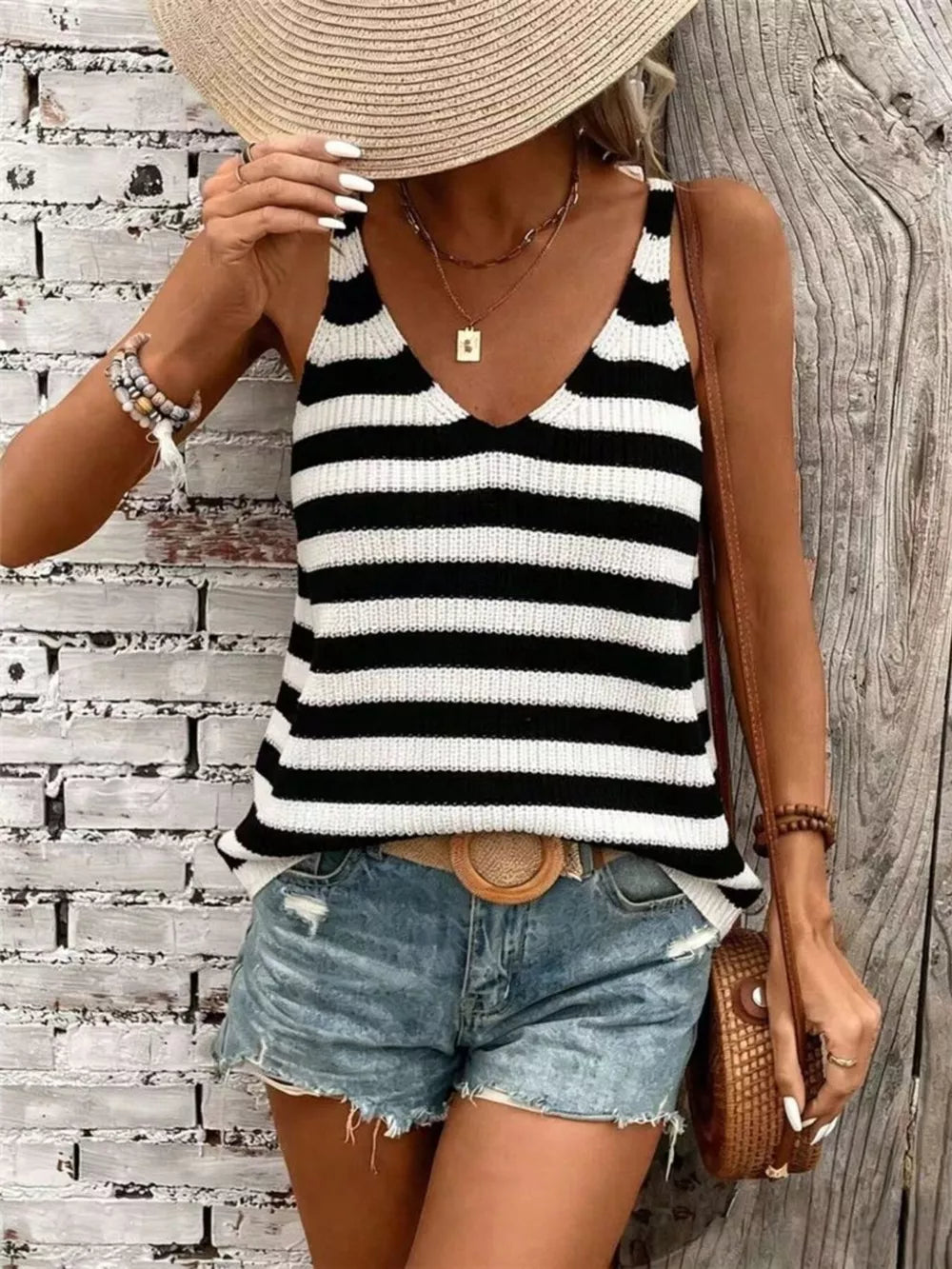 Relaxed black and white striped V-neck knit tank top with a relaxed fit.