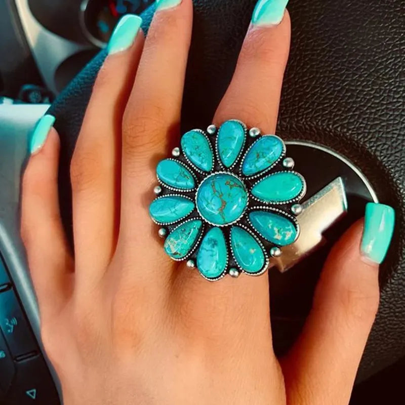 Turquoise blossom statement ring with artificial turquoise stones and alloy setting.