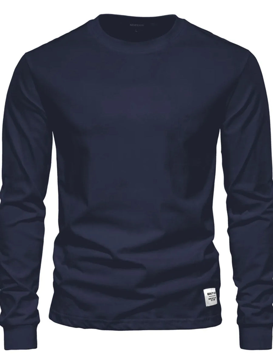 Navy crewneck long sleeve t-shirt with a small white tag detail on the hem.
