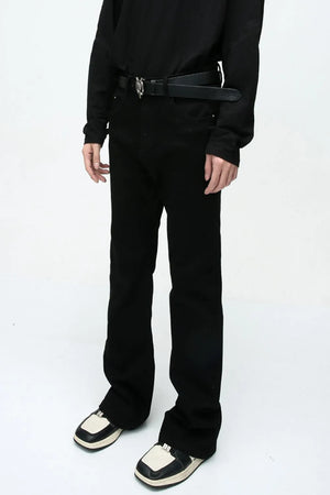 Flared leg black denim trousers with a casual 70s style.