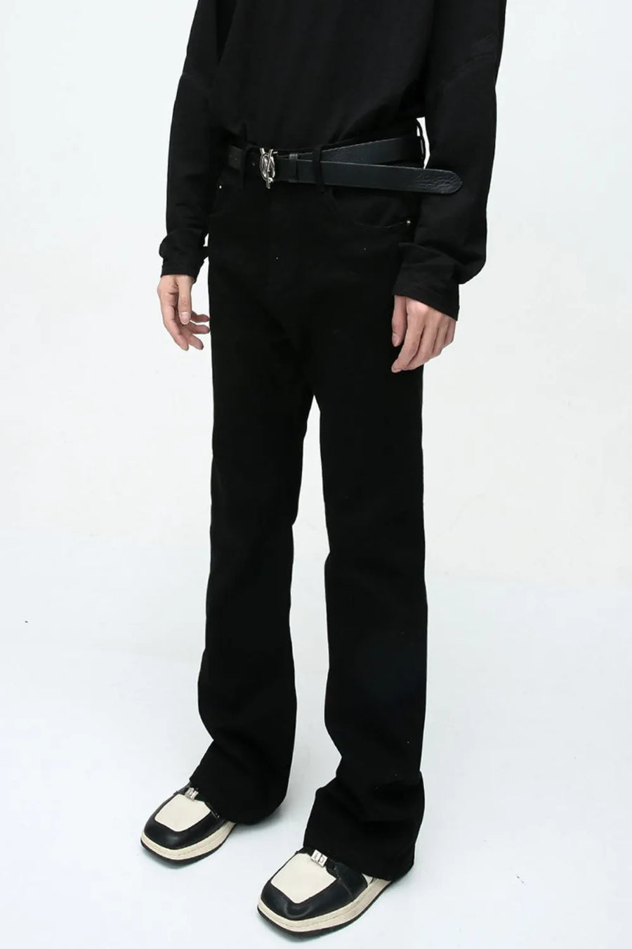 Flared leg black denim trousers with a casual 70s style.