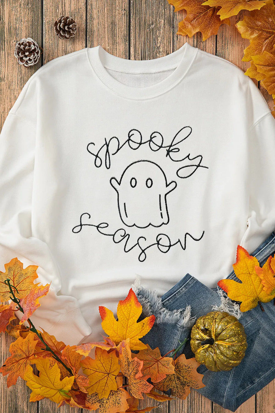 White sweatshirt with a black ghost graphic and "spooky season" script