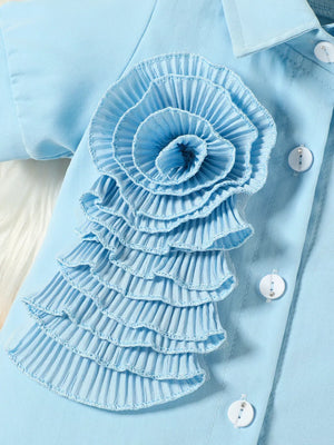 Blue toddler shirt with ruffled floral appliqué and decorative buttons