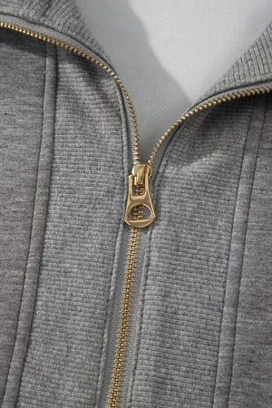 Chic dark gray half-zip polo top with gold zipper detail