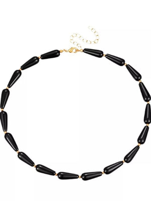Elegant black teardrop choker necklace with gold accents and clasp