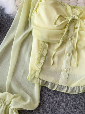Yellow green maternity blouse with ruffled sleeves, pearl buttons, and a decorative bow.